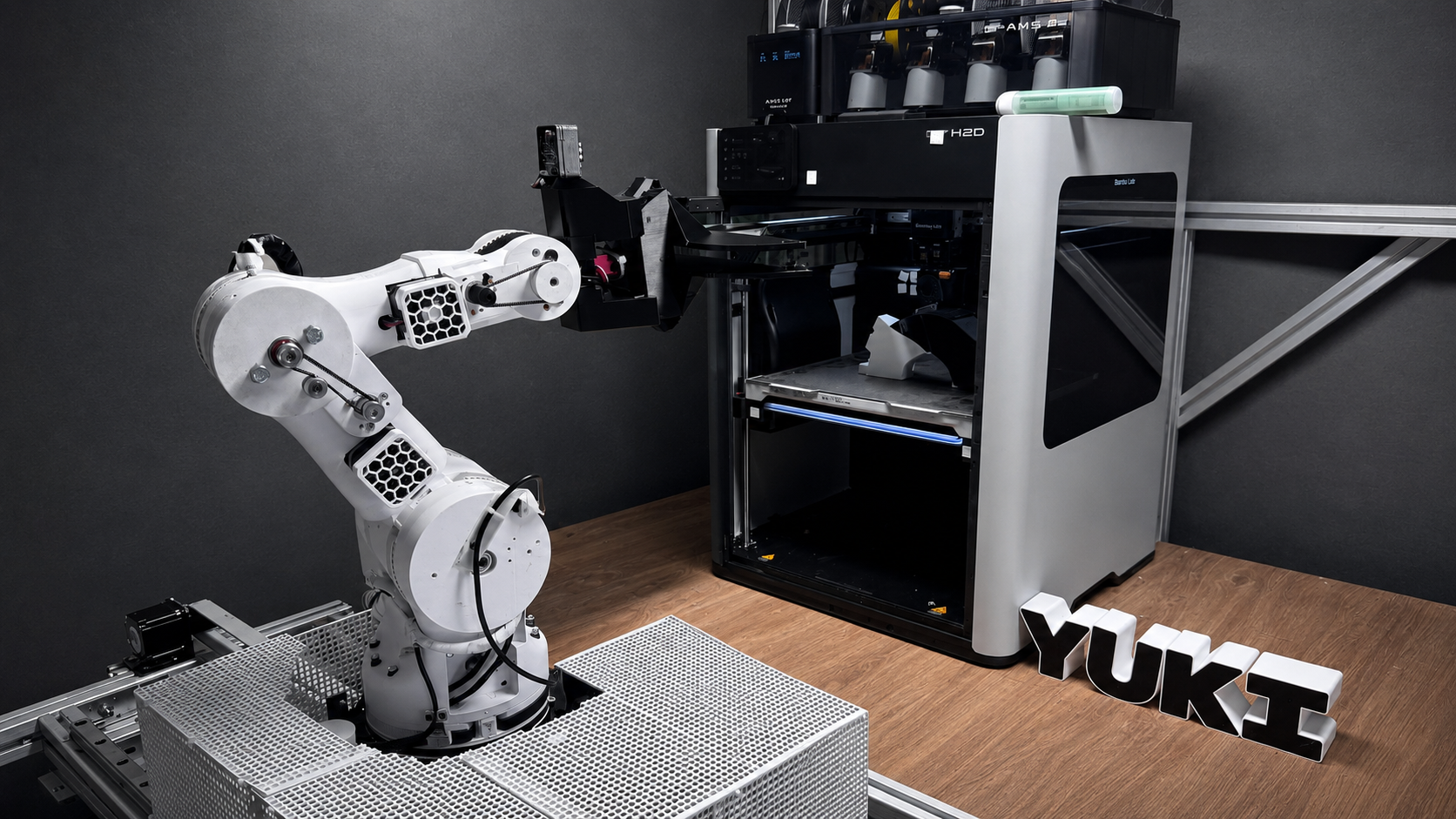 YUKI robotic arm working beside an industrial 3D printer